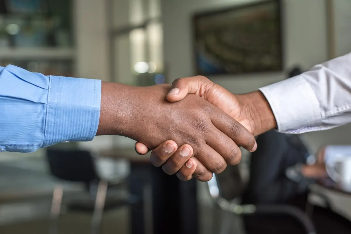 Handshake after signing a contract, business legal services